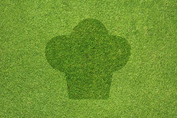 Иконка для приготовления на зеленом фоне и текстуре травы — стоковое фото