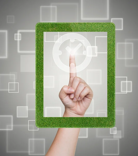 Hand pushing clock button of grass tablet on a touch screen — Stock Photo, Image