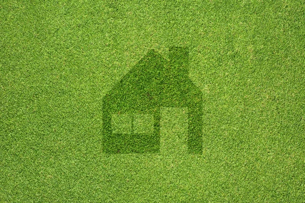Yeşil çim dokusu ve arka plan üzerinde ev simgesini — Stok fotoğraf