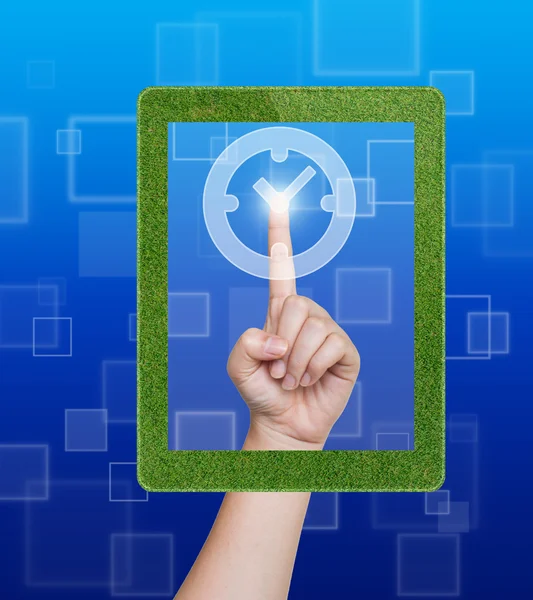 Hand duwen klok knop van gras tablet op een touchscreen — Stockfoto