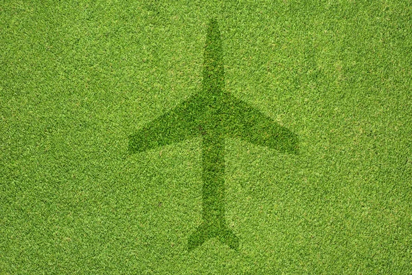 Flugzeug-Symbol auf grünem Gras Textur und Hintergrund — Stockfoto