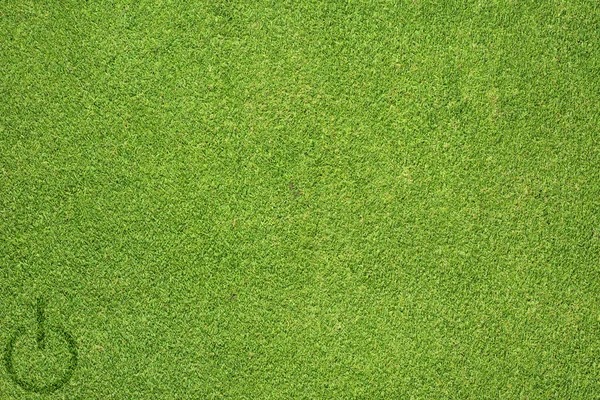 Shutdown icon on green grass texture and background — Stock Photo, Image