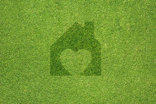 Home-Symbol auf grünem Gras Textur und Hintergrund — Stockfoto