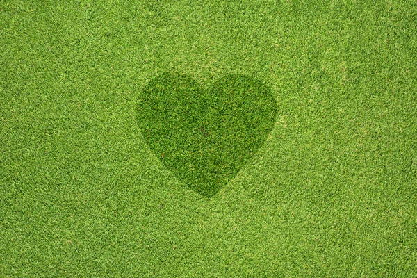Herz-Symbol auf grünem Gras Textur und Hintergrund — Stockfoto