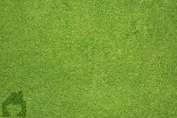 Домашня піктограма на зеленій текстурі трави та фоні — стокове фото