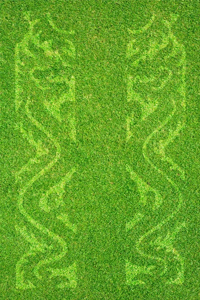 Иконка дракона на зеленой траве и фоне — стоковое фото