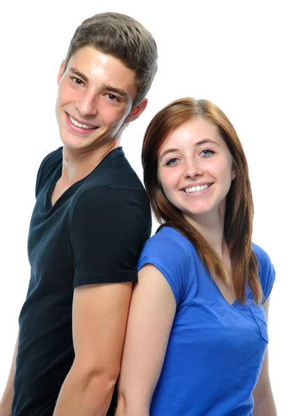 Teenage couple standing back to back Stock Photo
