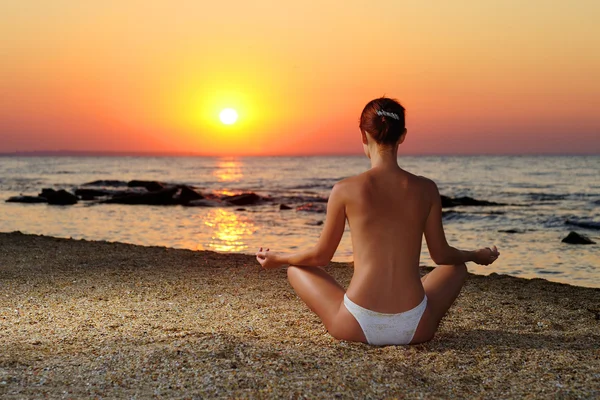 stock image Girl meditating in sunrise