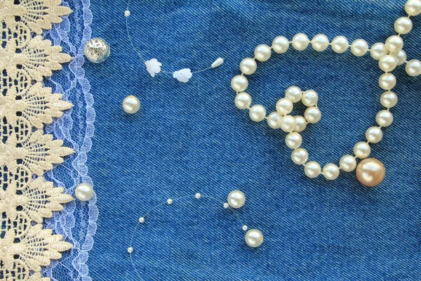 Greeting card with a sedets from a beads and laces on a jeans ba — Zdjęcie stockowe