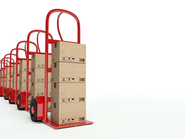Fila de camiones de mano con cajas de cartón — Foto de Stock