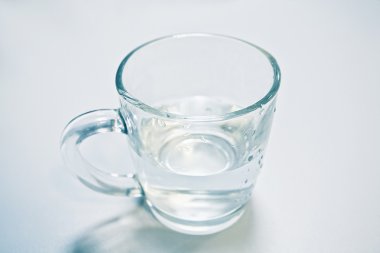 Clean water in a glass cup isolated clipart