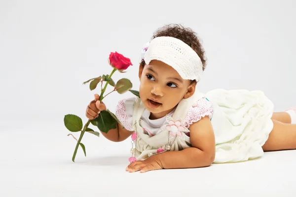 Lovely little girl with a rose — Stock Photo, Image