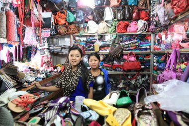 Young girls - Tibetan women sellers of the goods at the kiosk, North India clipart