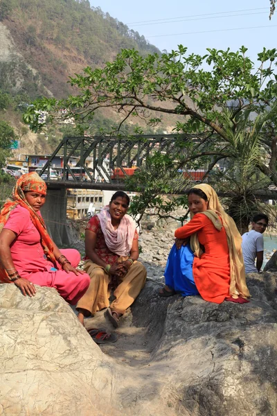 Three seated women in bright saris — Stock Photo, Image