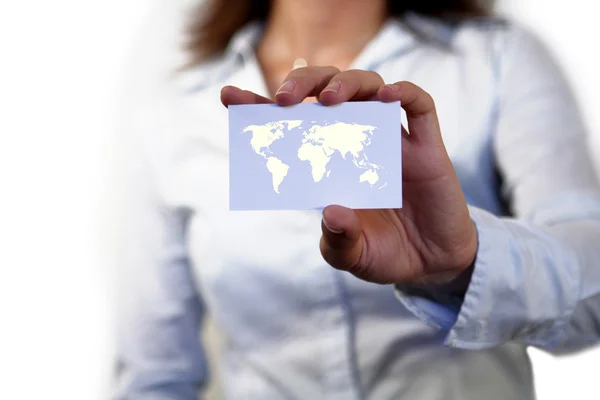Businesswoman holding blank card with map of the world — Stock Photo, Image