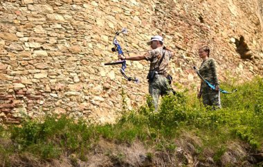 Young archer training with the bow clipart