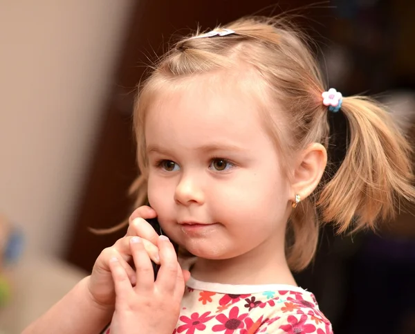 Маленькая девочка разговаривает по телефону — стоковое фото