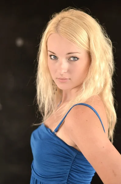 Young blonde woman posing in stylish blue dress — Stock Photo, Image