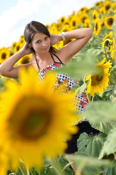 Portrait of young woman with sunflowers — Stock Photo, Image