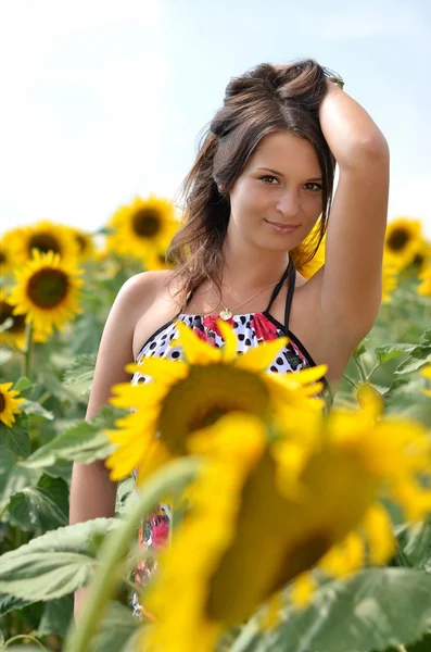 Portrait of young woman with sunflowers — Stock Photo, Image