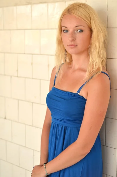 Молода блондинка позує в стильній блакитній сукні — стокове фото