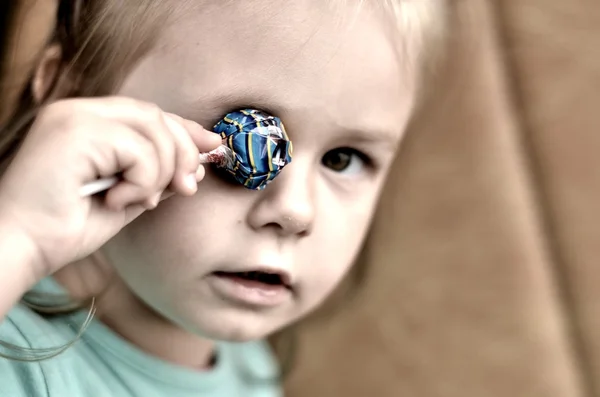 Little girl with a candy — Stock Photo, Image