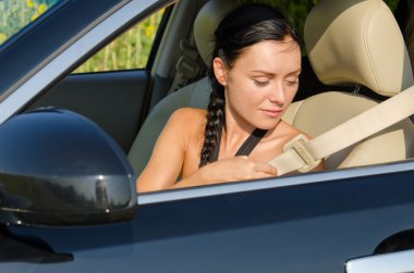 Woman putting on her seatbelt clipart