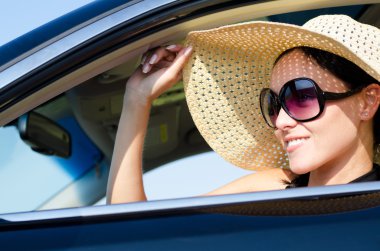 Beautiful woman sitting in a car clipart