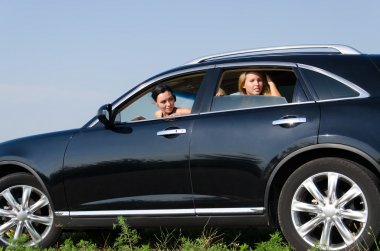 Women peering out of car windows clipart