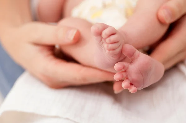 Segurando pés de bebê — Fotografia de Stock