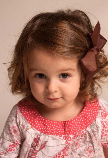 Baby girl with brown ribbon — Stock Photo, Image