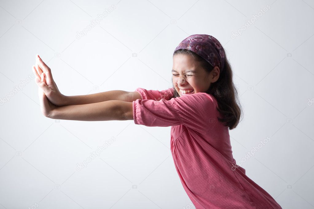 Young girl pushing imaginary wall