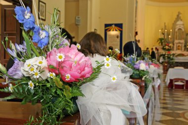 Flowers to adorn the nave of the Church during a wedding clipart