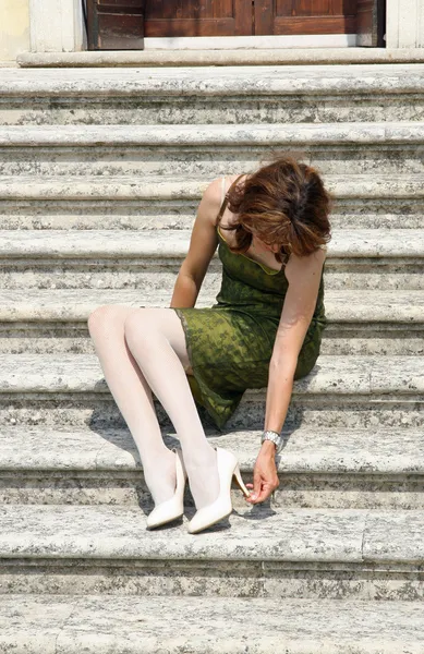 stock image Woman with shoes with heel problems and elegant dress