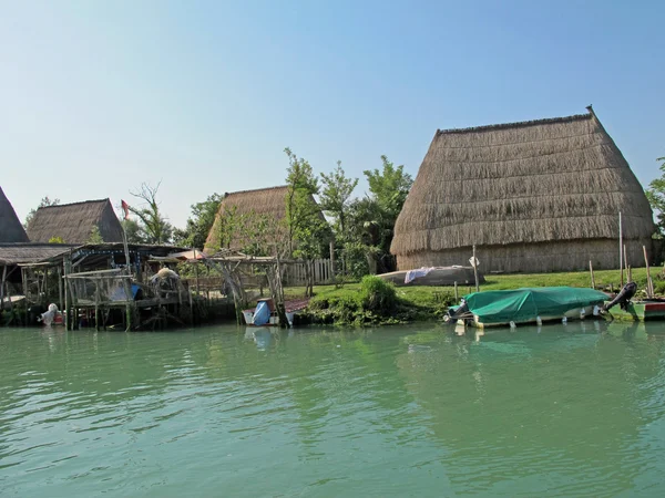 Stock image Old huts and piles of straw and wood where they dwelled fisherme