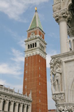 Bell Tower of St Mark and a statue of the palazzo ducale clipart