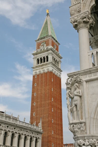 stock image Bell Tower of St Mark and a statue of the palazzo ducale