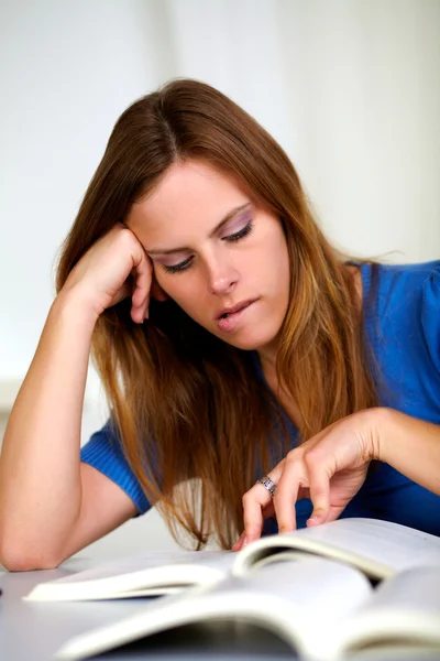 Beautiful tired blonde young girl studying — Stock Photo, Image