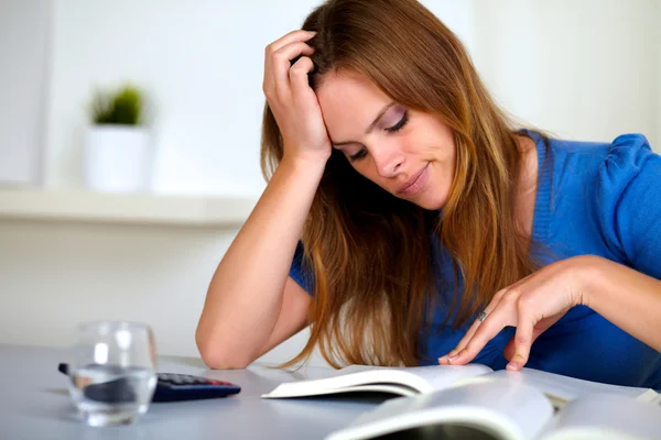 Adult pretty tired student girl reading a book — Stock Photo, Image