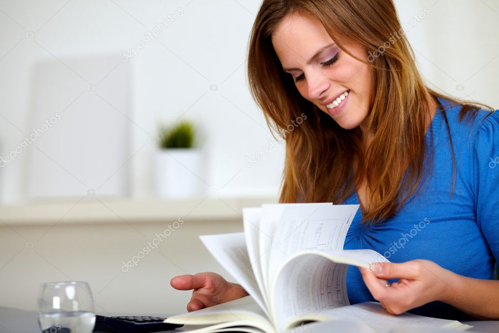 Blonde friendly young girl browsing a book