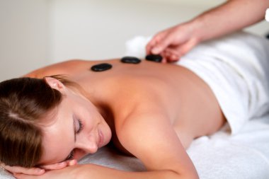 Tired young woman relaxing at a spa clipart