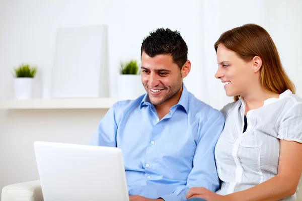 Счастливая молодая пара работает на ноутбуке — стоковое фото