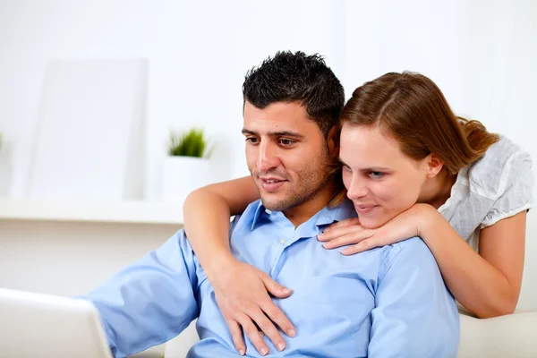 Good looking couple using laptop together — Stock Photo, Image