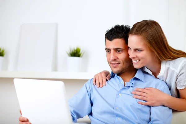 Beautiful couple using laptop together — Stock Photo, Image
