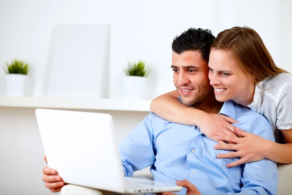 Charming couple using laptop together — Stock Photo, Image