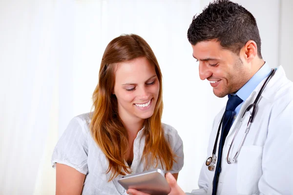 Médico latino e um paciente olhando para tablet PC — Fotografia de Stock