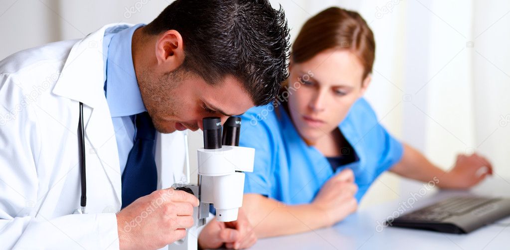 Handsome professional medical using a microscope