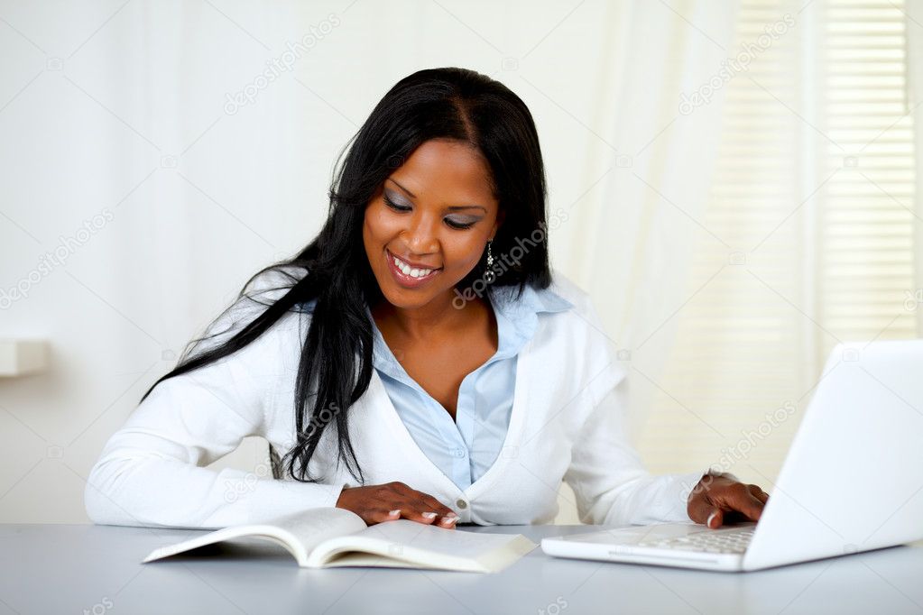 Charming student woman browsing a book