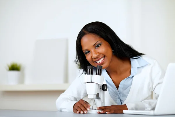 Charming young female using a microscope — Stock Photo, Image