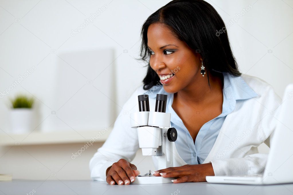 Pretty black female working with a microscope